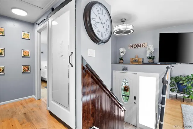 a living room with furniture a flat screen tv and a table