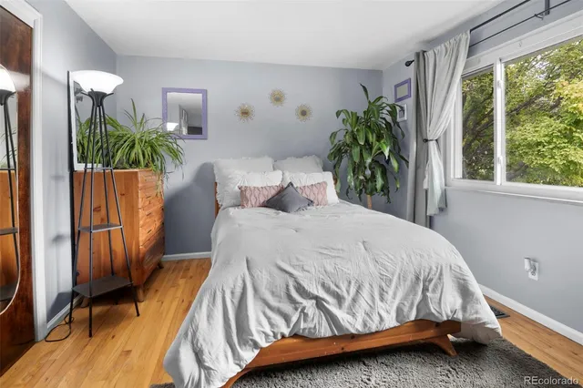 a bedroom with a bed and a flat tv screen on dresser