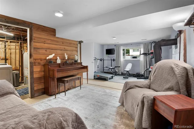 a living room with furniture a flat screen tv and a large window