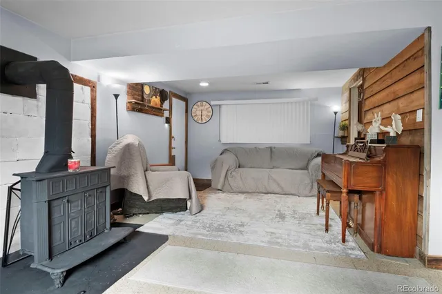 a living room with furniture and a gym machine