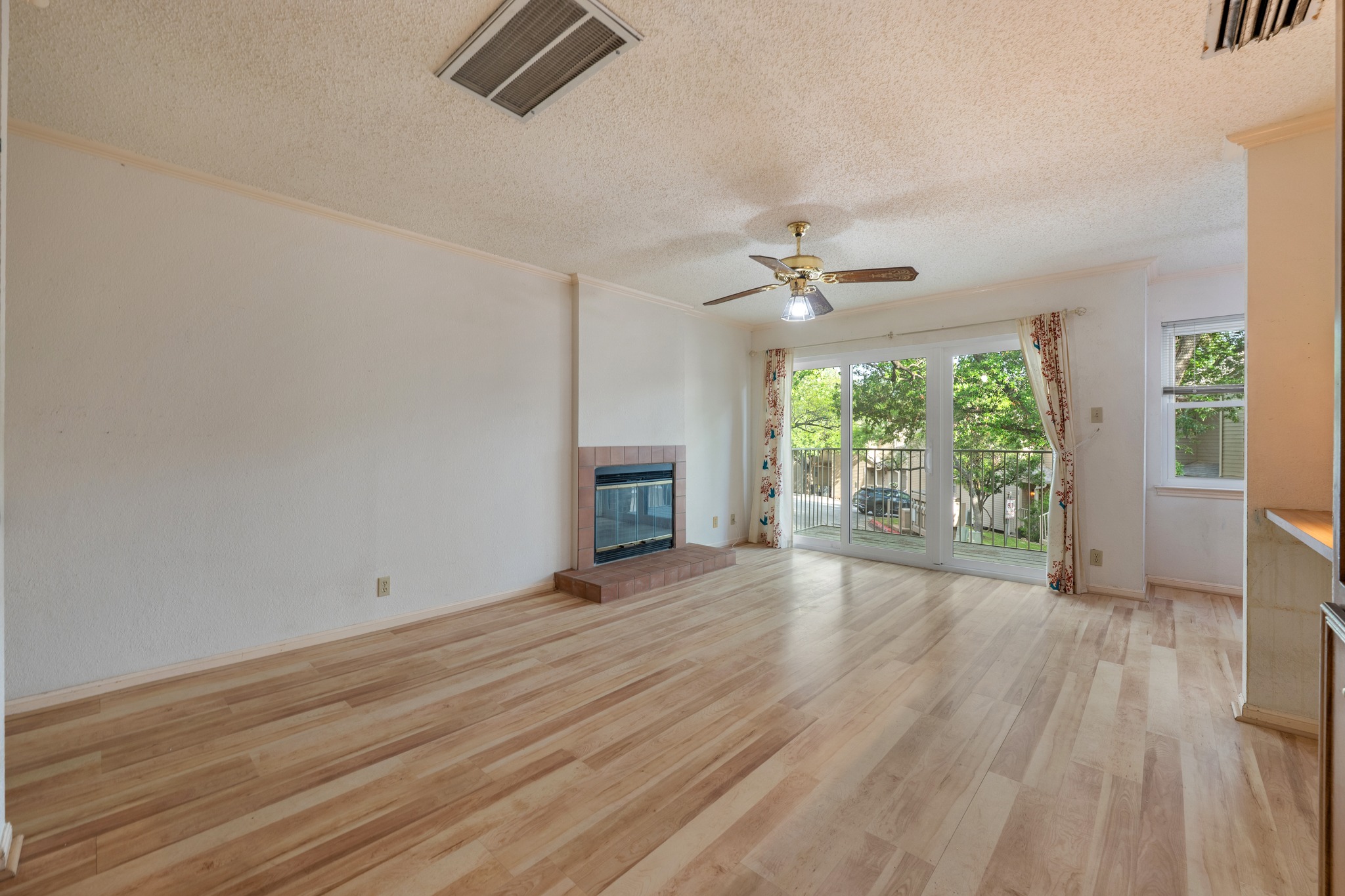 3845 Ranch Road 2222, Unit 19 Austin, TX 78731 - Photo 11 of 38 an empty room with wooden floor fan and windows