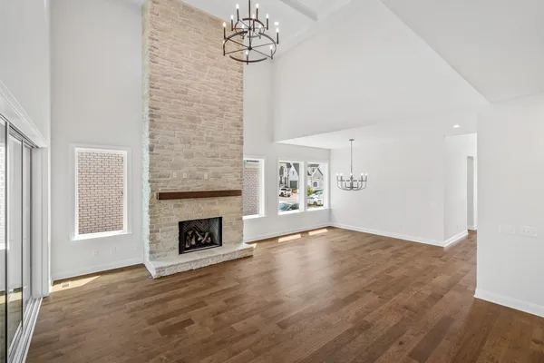 a large kitchen with a lot of counter space and wooden floor