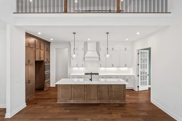 a kitchen with kitchen island a sink stainless steel appliances and cabinets