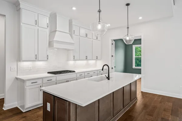 a kitchen that has a sink and a stove