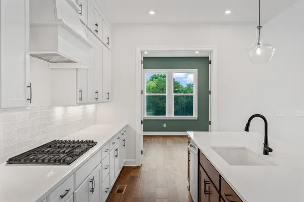 a kitchen with a sink chandelier and fireplace