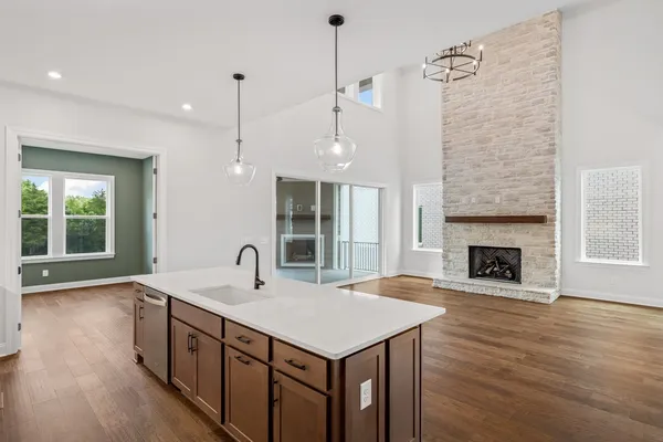 a kitchen with granite countertop a stove and a refrigerator