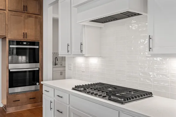 a view of a room with wooden floor and a window