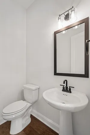 a view of a livingroom with wooden floor and a ceiling fan