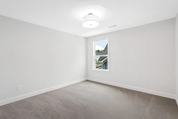 an empty room with windows and entrance