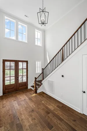 a view of empty room with wooden floor fireplace and windows