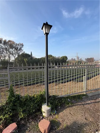 a view of a yard with a wooden fence