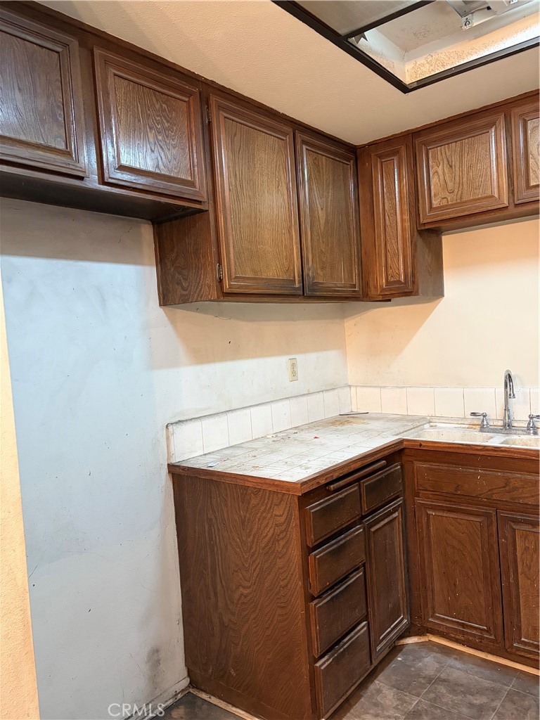 3054 Associated, Unit 20 Fullerton, CA 92835 - Photo 9 of 9 a kitchen with a sink a stove and cabinets