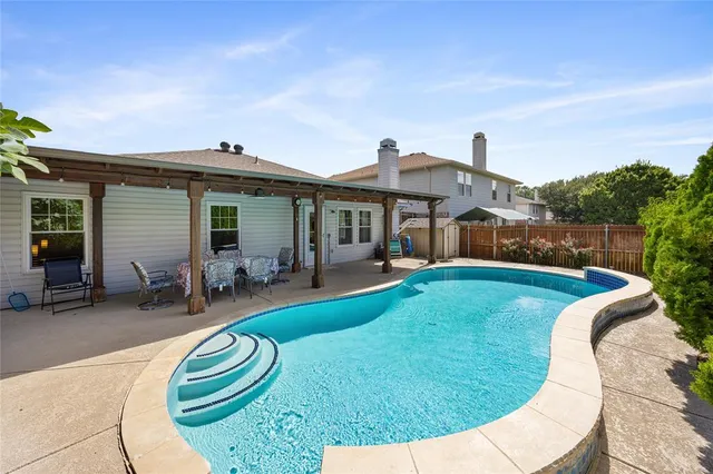 a view of a house with swimming pool and porch