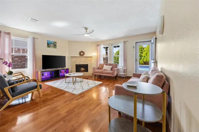 a living room with furniture flat screen tv and a large window