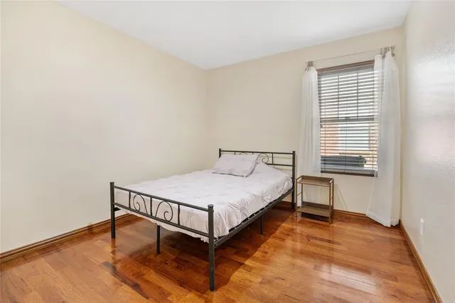 a bed sitting in a bedroom next to a window