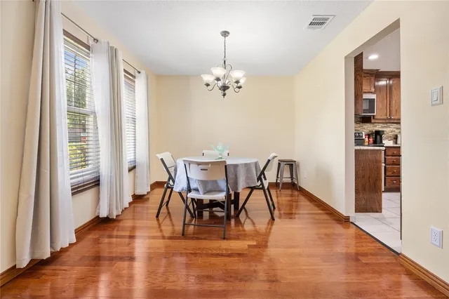 a view of a dining room with furniture window and wooden floor