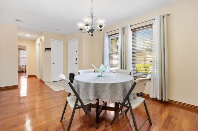 a view of a dining room with furniture and wooden floor