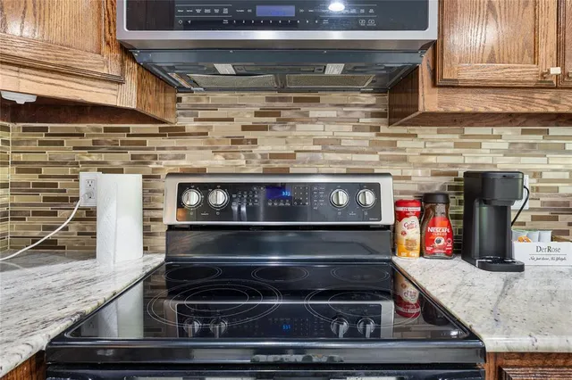 a stove top oven sitting inside of a kitchen