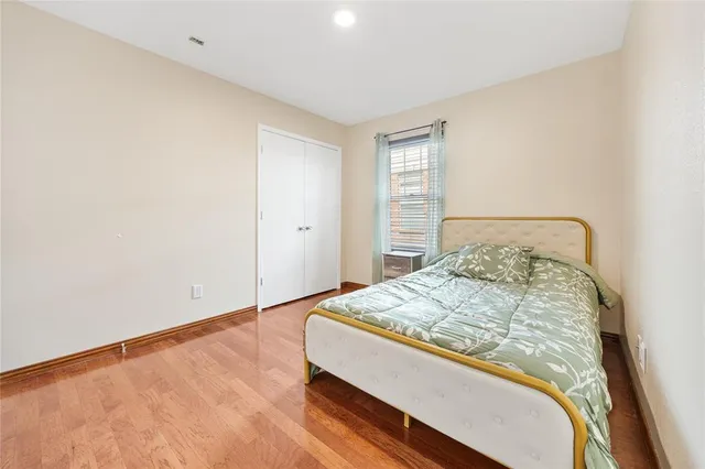 a bed sitting in a bedroom next to a window