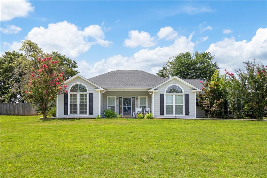 87 Lee Road Phenix City, AL 36867 - Photo 2 of 31 Light grey siding exterior with dark shutters and a dark grey shingle roof