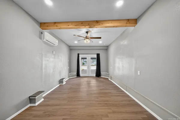 wooden floor in an empty room with a window