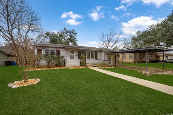 a front view of a house with a yard table and chairs
