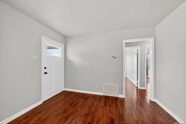 a view of a room with wooden floor