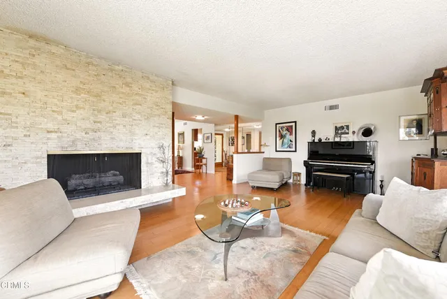 a living room with furniture and a fireplace