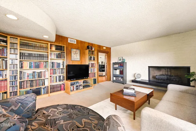 a living room with fireplace furniture and a flat screen tv