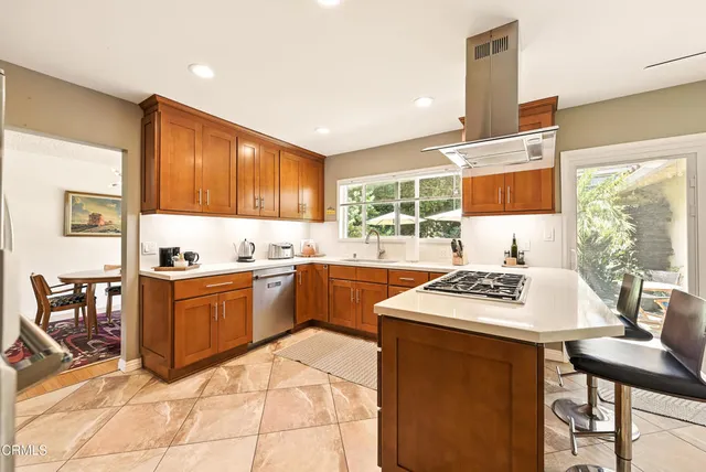 a kitchen with a sink cabinets and wooden floor