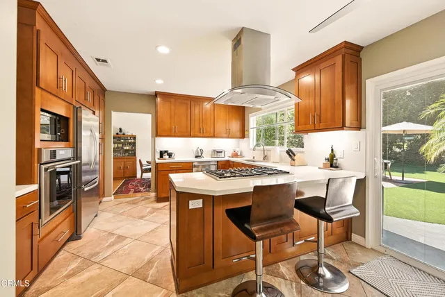 a kitchen with stainless steel appliances granite countertop a stove and a refrigerator