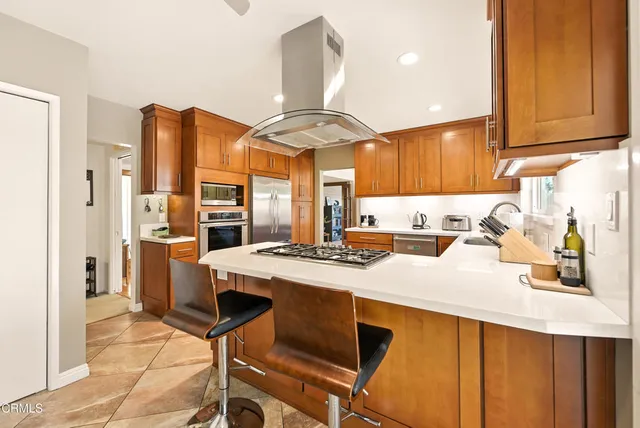 a kitchen with a stove a refrigerator and a sink