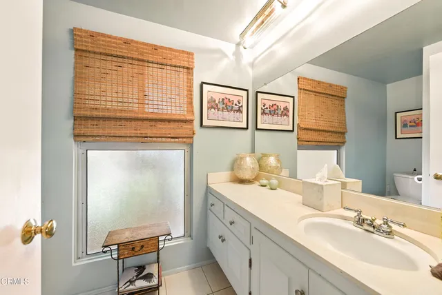 a bathroom with a sink a mirror and a shower