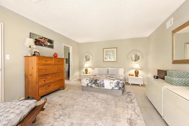 a living room with furniture and dresser
