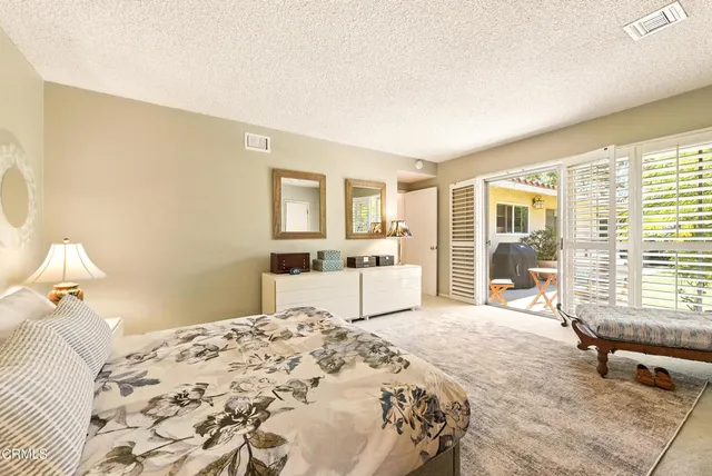 a bedroom with a large bed and a window