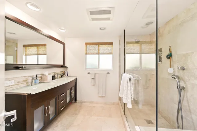 a bathroom with a double vanity sink mirror and double