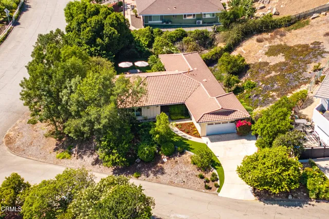 an aerial view of a house with a yard and garden