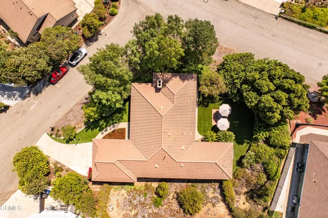 an aerial view of a house with a yard and a fountain