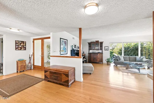 a living room with furniture and a large window