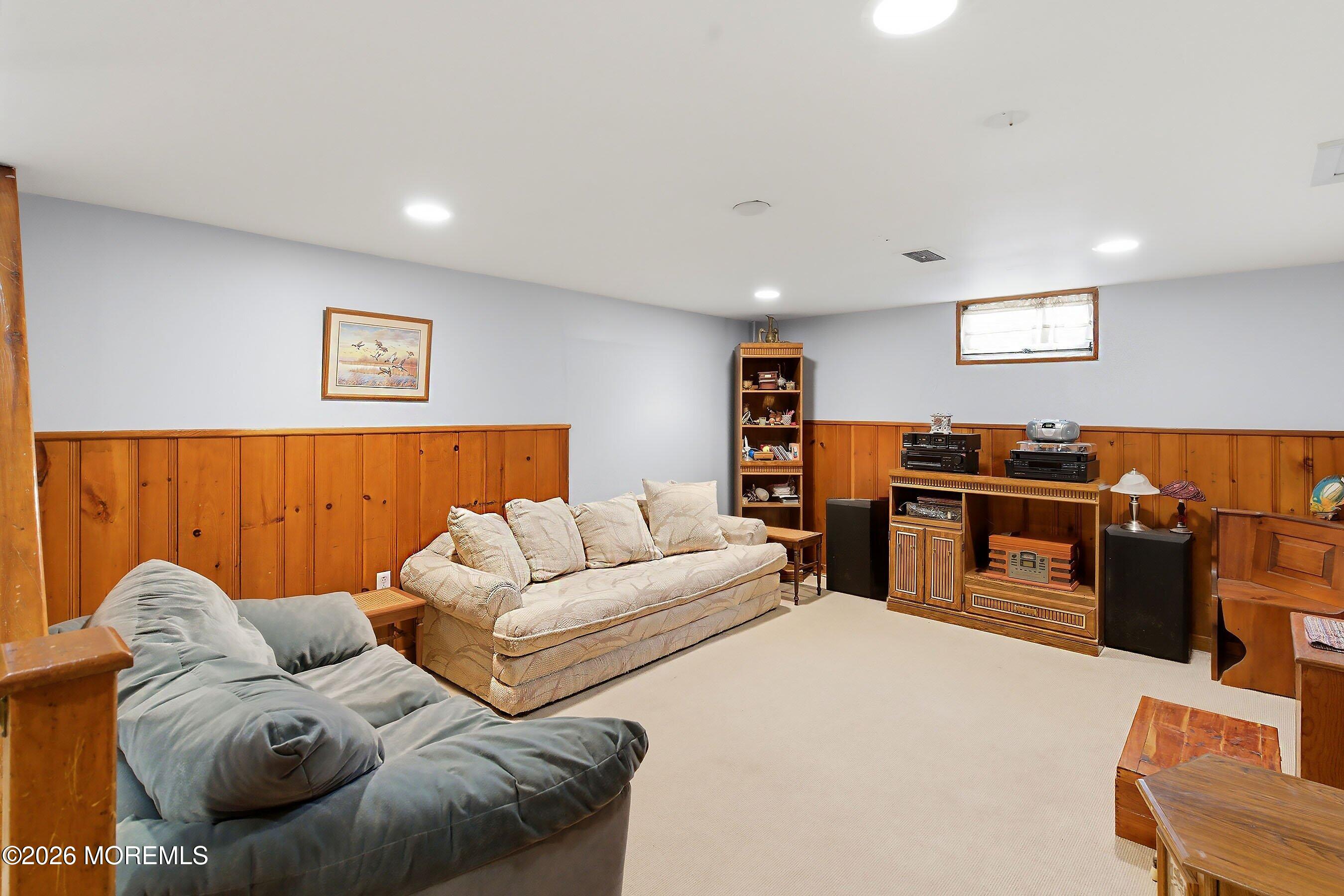 412 Moore Road Neptune Township, NJ 07753 - Photo 22 of 36 a living room with furniture and a flat screen tv