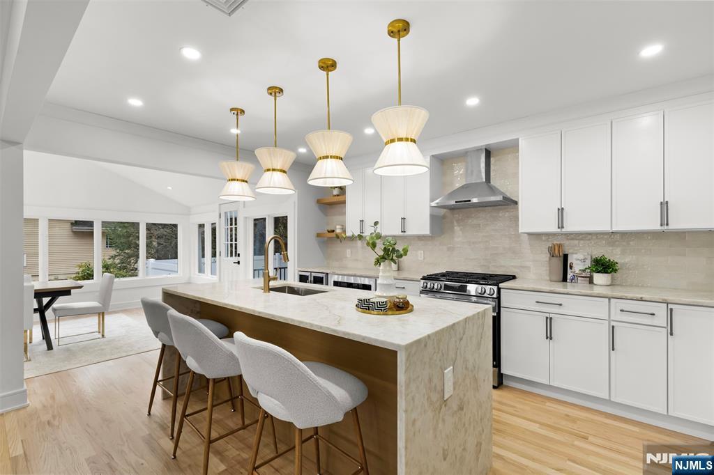 7 Chestnut Place Ho-Ho-Kus, NJ 07423 - Photo 11 of 36 a kitchen with a stove a center island a dining table and chairs