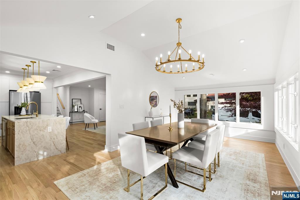 7 Chestnut Place Ho-Ho-Kus, NJ 07423 - Photo 13 of 36 a living room with furniture a chandelier and a dining table