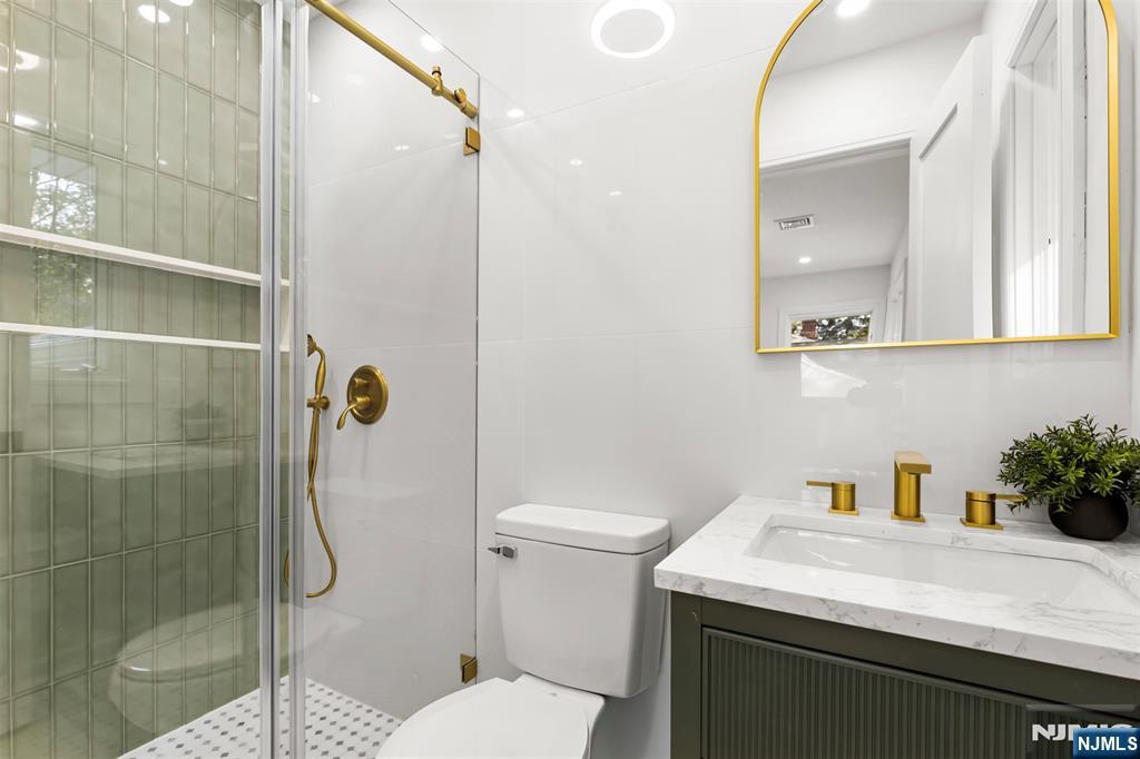 7 Chestnut Place Ho-Ho-Kus, NJ 07423 - Photo 20 of 36 a bathroom with a sink toilet and shower