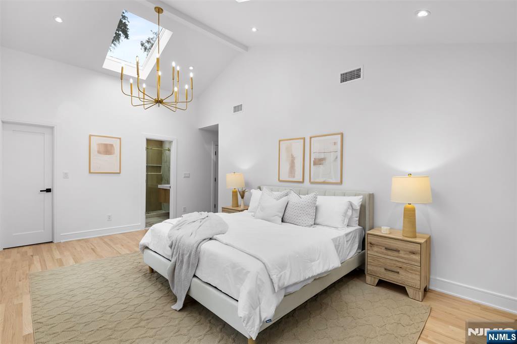 7 Chestnut Place Ho-Ho-Kus, NJ 07423 - Photo 21 of 36 a bedroom with bed and a chandelier