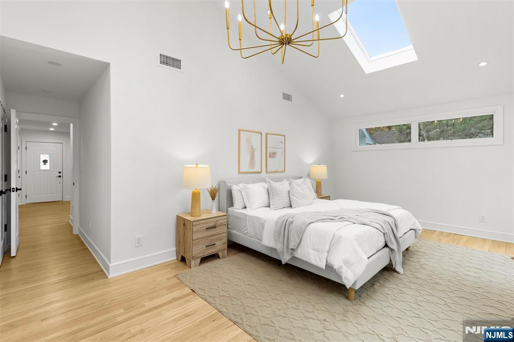 7 Chestnut Place Ho-Ho-Kus, NJ 07423 - Photo 23 of 36 a bedroom with a bed and wooden floor