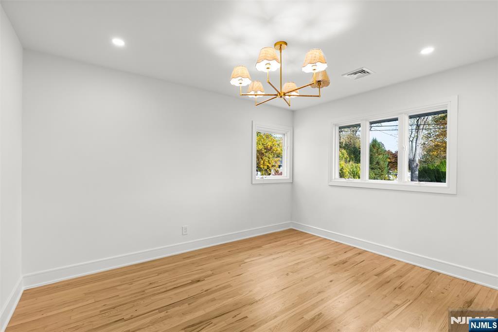 7 Chestnut Place Ho-Ho-Kus, NJ 07423 - Photo 26 of 36 a view of a room with wooden floor and chandelier