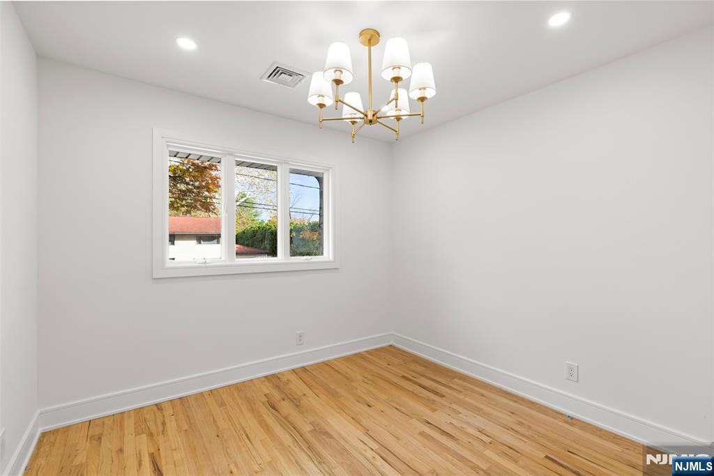 7 Chestnut Place Ho-Ho-Kus, NJ 07423 - Photo 28 of 36 wooden floor in an empty room with a window