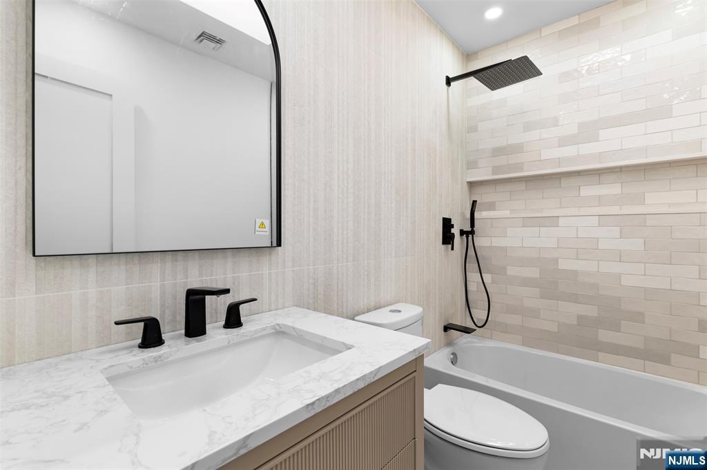 7 Chestnut Place Ho-Ho-Kus, NJ 07423 - Photo 30 of 36 a bathroom with a granite countertop sink toilet and shower