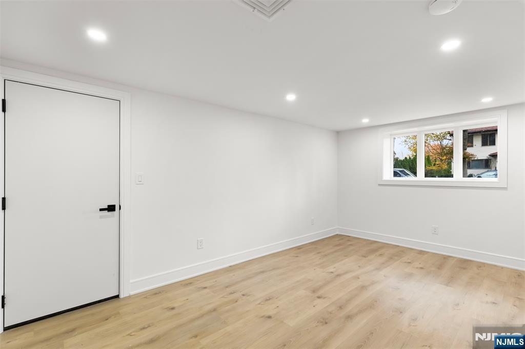 7 Chestnut Place Ho-Ho-Kus, NJ 07423 - Photo 31 of 36 a view of empty room with wooden floor and fan