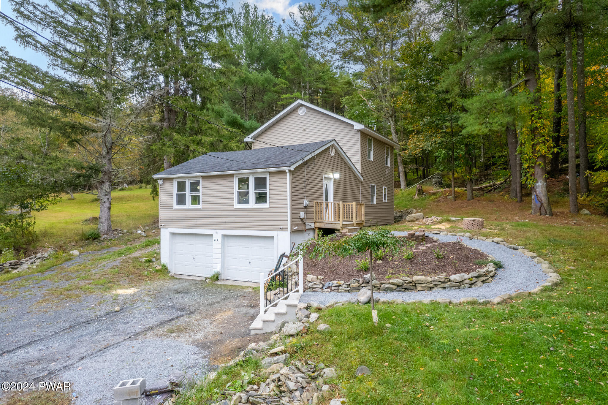 144 Log Tavern Road Milford, PA 18337 - Photo 5 of 45 a front view of a house with a yard and trees